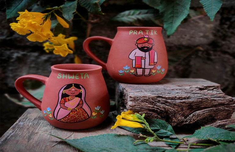 Two beakers with hand painting.